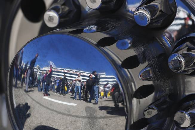 Fans are reflected in the hubcap of a truck before the Monster Energy NASCAR Cup Series Pennzoil 400 Sunday, March 4, 2018, at the Las Vegas Motor Speedway.