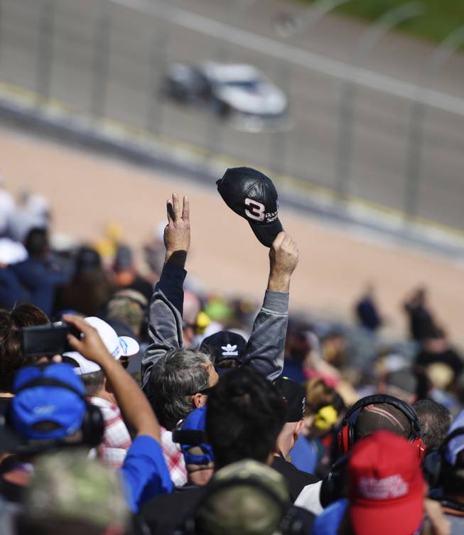 A fan holds up three fingers and his hat in honor of Dale Earnhardt during the third lap of the Monster Energy NASCAR Cup Series Pennzoil 400 Sunday, March 4, 2018, at the Las Vegas Motor Speedway.