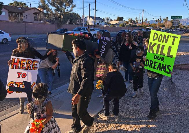 Supporters of the Deferred Action for Childhood Arrival program take to the streets Monday, March 5, 2018, in central Las Vegas. 