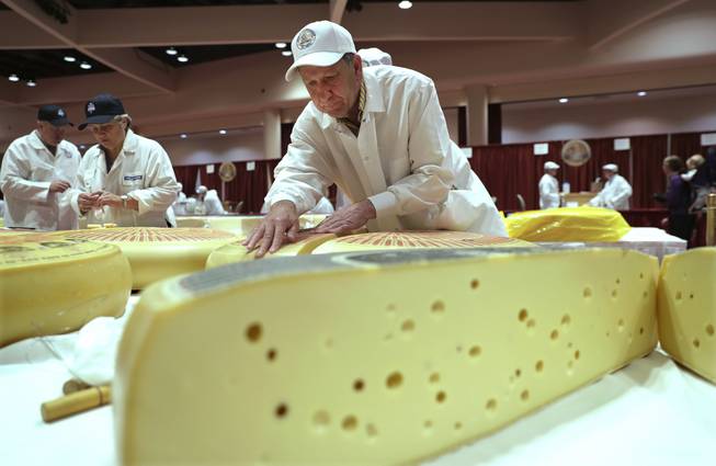 Christophe Megevand, of Schuman Cheese, New Jersey, judges the Rhined Swiss Style Cheese category in the opening day of the World Championship Cheese Contest at the Monona Terrace in Madison, Wis., Tuesday, March 6, 2018.