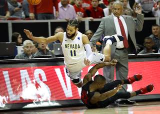Nevada Wolf Pack forward Cody Martin (11) and UNLV Rebels guard Jordan Johnson (24) go out of bounds while chasing a loose ball during a 2018 Mountain West Men's Basketball Championship game at the Thomas & Mack Center Thursday, March 8, 2018.