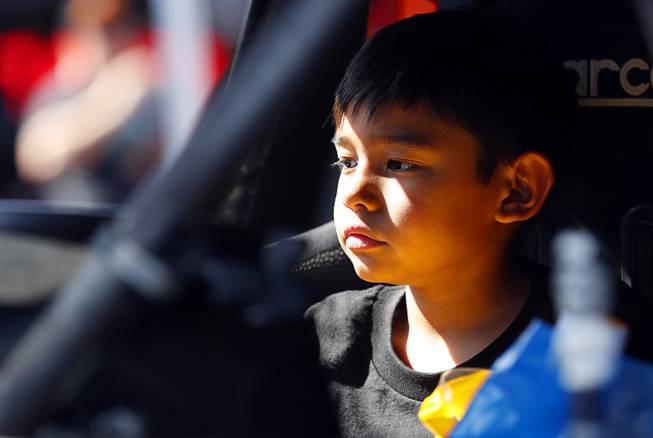 Nathan Danger Stires, 8, of Menifee, Calif., son of crew chief Clyde Stires, waits in a racing vehicle for an inspection during a Mint 400 tech and contingency event on East Fremont Street in downtown Las Vegas Friday, March 9, 2018. The Mint 400 off road race takes place Saturday in Primm.