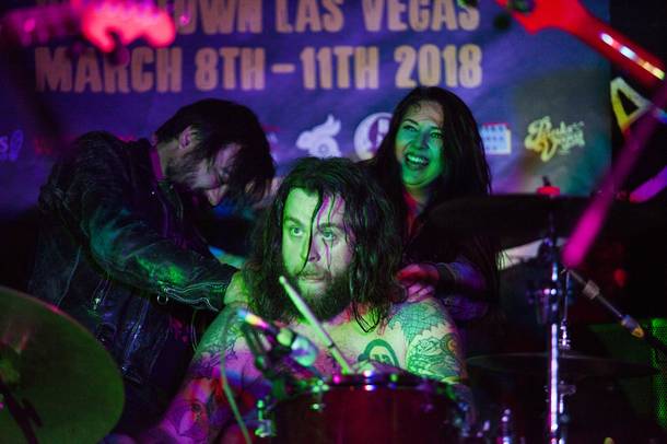 Tight Fright drummer Aharon Carlos Danger Lund receives a massage from two fans during the last song of their set at Beauty Bar during the Neon Reverb music festival, early morning Friday, March 9, 2018.