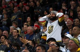 A fan looks toward the scoreboard as the Vegas Golden Knights play the New Jersey Devils at T-Mobile Arena Wednesday, March 14, 2018. The Devils beat the Knights 8-3.
