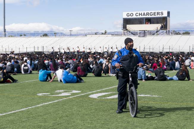 School Police Officer Anthony Cooke stands by during a nationwide school walkout to honor the victims of the Feb. 14 Marjory Stoneman Douglas High School mass shooting and to protest gun laws, Wednesday, March 14, 2018. Clark High School students honored the Parkland, FL Marjory Stoneman Douglas High School shooting victims with seventeen minutes of silence, one minute for each of the victims.