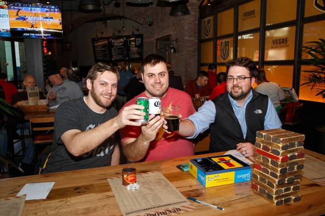 From left, Tyler Borland, Chris Shumaker and Joseph Nixon of Columbus, Ohio, pose for a photo during the first rounds of March Madness at Beerhaus, Thursday, March 15, 2018.