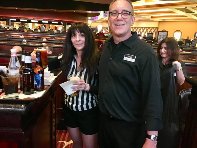 Green Valley Resort bartender Tony Deppe and server Nicole Ervolino work the sports book during the NCAA Tournament on March 15, 2018.
