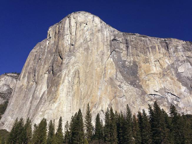 FILE - This Jan. 14, 2015 file photo shows El Capitan in Yosemite National Park, Calif. An elite rock climber has become the first to climb alone to the top of the massive granite wall in Yosemite National Park without ropes or safety gear. National Geographic documented Alex Honnold's historic ascent of El Capitan on Saturday, June 3, 2017, saying the 31-year-old completed the "free solo" climb Saturday in nearly four hours. (AP Photo/Ben Margot, File)