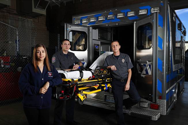 Kaitlyn Rogers, special event assistant, Oscar Monterrosa, center, paramedic, and Glen Simpson, special event manager, pose by an ambulance at Community Ambulance in Henderson Friday, March 16, 2018. Community Ambulance paramedics were working at the Route 91 music festival during the Oct. 1 mass shooting.