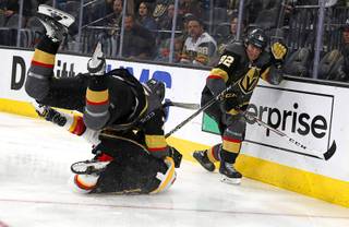 Vegas Golden Knights right wing Ryan Reaves, top, (75) collides with Calgary Flames defenseman TJ Brodie (7) as Vegas Golden Knights left wing Tomas Nosek (92) looks on during the second period of an NHL hockey game Sunday, March 18, 2018, in Las Vegas.