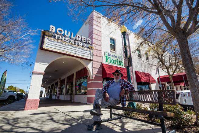 A man sits outside Boulder Theatre in Boulder City, Friday, Mar. 3, 2018.