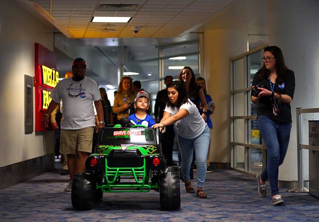 Make-A-Wish recipient Nicolas "Quatro" Dones IV drives from the gate, with help from his sister Iliana, 16, at McCarran International Airport Wednesday, March 21, 2017. Quatro arrived on Allegiant Air's 1,000th wish flight. A monster truck fan, Quatro wanted to come to Las Vegas to attend this weekend's Monster Jam World Finals XIX at Sam Boyd Stadium.