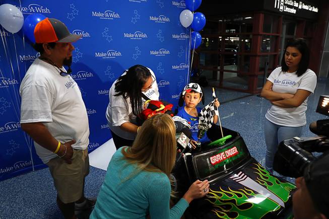 Make-A-Wish recipient Nicolas "Quatro" Dones IV is interviewed by a television news reporter after arriving at McCarran International Airport Wednesday, March 21, 2017. With Quatro is his father Nicolas Dones III, mother Myra and sister Iliana. Quatro arrived on Allegiant Air's 1,000th wish flight. A monster truck fan, Quatro wanted to come to Las Vegas to attend this weekend's Monster Jam World Finals XIX at Sam Boyd Stadium.