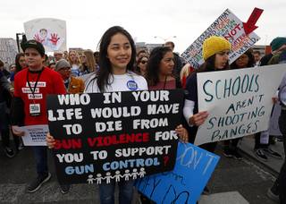 Valeria Medina, center, a Valley High School junior, waits for the start of a March For Our Lives event in downtown Las Vegas Saturday, March 24, 2018. Over 2,000 people participated in the march and a rally in front of Las Vegas City Hall.