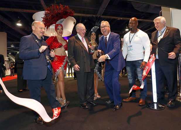 Former NFL quarterback Ron Jaworski, center, cuts a ribbon with former Mayor Oscar Goodman and other officals to open the trade show floor during the annual Nightclub and Bar Show at the Las Vegas Convention Center Tuesday, March 27, 2018.