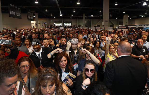 Attendees display their wristbands as the trade show floor opens during the annual Nightclub and Bar Show at the Las Vegas Convention Center Tuesday, March 27, 2018.