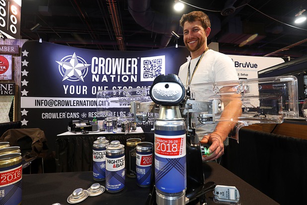 Jeremy Rudolf of Crowler Nation shows of the company's beer canning machine during the annual Nightclub and Bar Show at the Las Vegas Convention Center Tuesday, March 27, 2018. A Crowler (Can + growler) is a 32-oz. can filled with fresh craft beer.