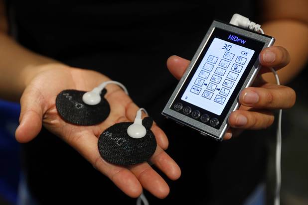 A HiDow massage device is displayed during the annual Nightclub and Bar Show at the Las Vegas Convention Center Tuesday, March 27, 2018. The battery-operated device uses transcutaneous (through the skin) electrical nerve stimulation to relieve pain and provide other therapeutic benefits.