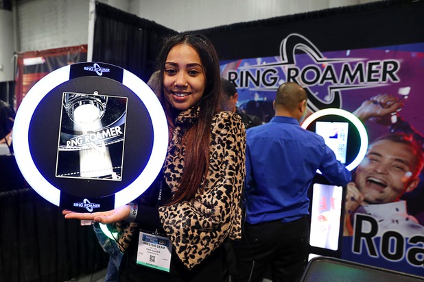 Sweetie Deam poses with a Ring Roamer during the annual Nightclub and Bar Show at the Las Vegas Convention Center Tuesday, March 27, 2018. The Ring Roamer combines an iPad and a ring light to capture and share photos to social networks during events.