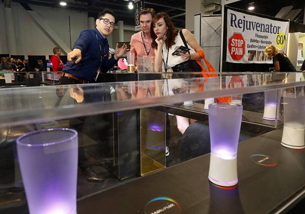 A represntative shows off the at the RadioFlux booth during the annual Nightclub and Bar Show at the Las Vegas Convention Center Tuesday, March 27, 2018. The company makes Internet-enabled Yoola Cups that incorporate lighting control technology and can alert a server when the glass is empty.