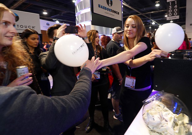 Elisa Renaut hands out balloons containing a micro-droplet mists of liquid alcohol at the Vapshot booth during the annual Nightclub and Bar Show at the Las Vegas Convention Center Tuesday, March 27, 2018. The mists have 1/60 the calories of a typical 1 oz. shot and the effects wear off in about 30 minutes, according to the company's website.