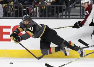 Vegas Golden Knights left wing Pierre-Edouard Bellemare (41) passes around Colorado Avalanche left wing Matt Nieto (83) during the first period of an NHL hockey game, Monday, March 26, 2018, in Las Vegas.