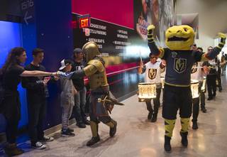 The Vegas Golden Knight and Chance the Golden Gila Monster lead a parade through the concourse level of T-Mobile Arena before an NHL hockey game against the Arizona Coyotes at T-Mobile Arena Wednesday, March 28, 2018.