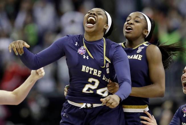 Notre Dame's Arike Ogunbowale, left, is congratulated by teammate Jackie Young after sinking a 3-point basket to defeat Mississippi State 61-58 in the final of the women's NCAA Final Four college basketball tournament, Sunday, April 1, 2018, in Columbus, Ohio. 