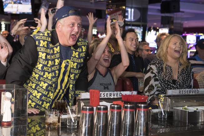 Derek Stevens, CEO and co-owner of The D Las Vegas, reacts along with his wife Nicole, center, and daughter Whitney while watching his alma mater Michigan take on Loyola in the Final Four Saturday, March 31, 2018, at The D. Stevens has placed a $25,000 bet on Michigan to win the NCAA basketball tournament and stands to win $1 million if they do. CREDIT: Sam Morris/Las Vegas News Bureau