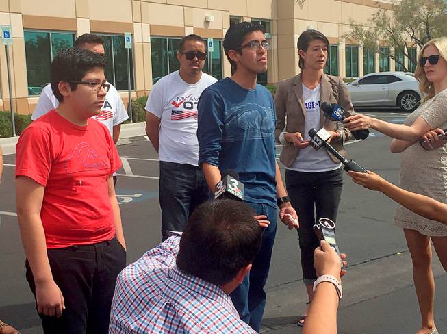 Eric Avalar-Gomez, front left, Ricardo Avalar-Gomez, center, and Bliss Requa-Trautz right, speak outside the Las Vegas office of U.S. Citizenship and Immigration Services Thursday, April 5, 2018, to call on immigration authorities to release from custody Mexican national Cecilia Gomez. 