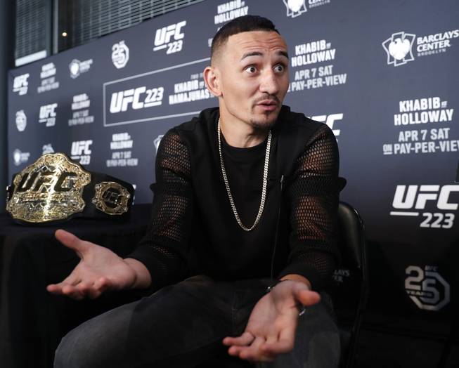 UFC featherweight champion Max Holloway gestures while responding to reporters' questions during Media Day for UFC223, Thursday, April 5, 2018, at the Barclays Center in New York ahead of his upcoming lightweight title fight against Khabib Nurmagomedov.