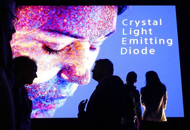 Attendees are silhouetted in front of a giant "Crystal LED" display during the National Association of Broadcasters (NAB) show at the Las Vegas Convention Center Tuesday, April 10, 2018. The convention runs through April 12 and is expected to draw more than 100,000 attendees from 160 countries.