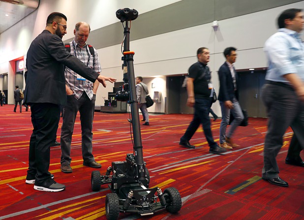 Azad Abbasi, left, founder and CEO of Genius Marketing, shows off the "Samsung Rover" during the National Association of Broadcasters (NAB) show at the Las Vegas Convention Center Tuesday, April 10, 2018. The rover is based on a Mantis platform with a 17-camera Samsung 360 Round on top. The remote-controlled rover can create and stream 360-degree video in 4K without getting the operator in the video.
