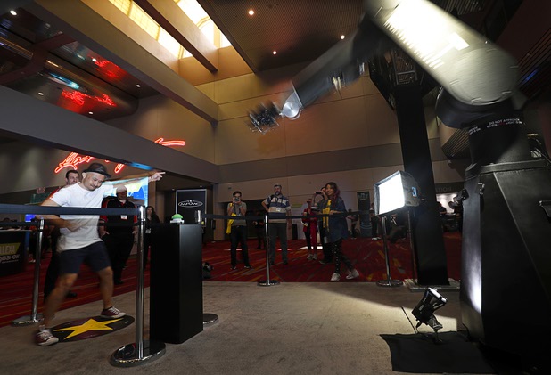 John Barros, of Toronto, Canada, dances for the Bolt High-Speed Cinebot in the lobby of the Las Vegas Convention Center during the National Association of Broadcasters (NAB) show at the Las Vegas Convention Center Tuesday, April 10, 2018. The Bolt is produced by Mark Roberts Motion Control of England.