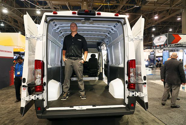 Erik Natzke, a Ram commercial product specialist, stands in a 2017 Ram Promaster van during the National Association of Broadcasters (NAB) show at the Las Vegas Convention Center Tuesday, April 10, 2018. Natzke is 6' 4" but still can stand up straight in the van.