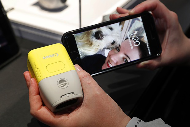 A prototype Canon camera is attached to an iPhone during the National Association of Broadcasters (NAB) show at the Las Vegas Convention Center Tuesday, April 10, 2018. The camera can capture high-quality images at a focal length of 100mm and 400mm, a representative said.