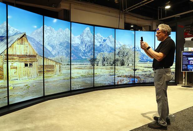 A man takes a photo of a Sharp "Double 8K" video wall display during the National Association of Broadcasters (NAB) show at the Las Vegas Convention Center Tuesday, April 10, 2018.