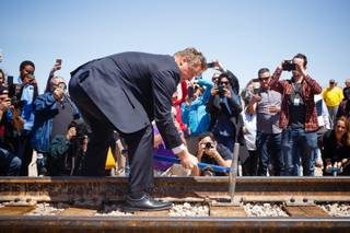 U.S. Senator Dean Heller (R-NV) drives a final spike into a railroad track during an event to celebrate reconnecting the Nevada Southern Railway from Boulder City to Henderson, Friday, April 13, 2018.