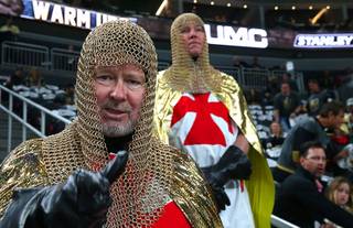 Vegas Golden Knights fans Niels Hartvig-Nielsen, left, and David Pelckai are dressed as knights during an NHL hockey first-round play-off series against the Los Angeles Kings at T-Mobile Arena Friday, April 13, 2018.