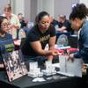 Maria Makupson, right, gets a business card with information on how to apply for a job from Nike recruiter Aubrey Pasadas during the LGBT Career Fair at The Gay & Lesbian Career Center of Southern Nevada, Wednesday, April 4, 2018.