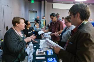 Job seekers look over job application information from the Las Vegas Clark County Library District during the LGBT Career Fair at The Gay & Lesbian Career Center of Southern Nevada, Wednesday, April 4, 2018. The library district offers 6 week courses in a variety of career subjects to anyone with a library card.