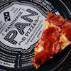 This Oct. 21, 2016, file photo shows a slice of pepperoni pizza on a Domino's Pizza box in Derry, N.H.