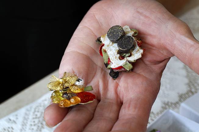 Dottie Do Turner displays decorative kitchen magnets, based on a plastic bag clip, in her home Thursday, April 19, 2018. Instead of throwing everyday items into the trash, Turner repurposes them into useful crafts.