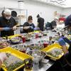 Workers trim marijuana buds in the Green Life Productions grow facility trim room in Las Vegas Thursday, April 19, 2018.