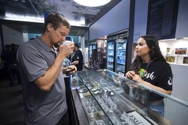Alyssa Justino helps Michael Brousseau as he shops at Exhale Nevada dispensary during a dispensary bus tour sponsored by the Las Vegas Medical Marijuana Association Friday, April 20, 2018.