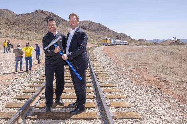 Nevada Governor Brian Sandoval, left, and Sen. Dean Heller pose on the tracks after driving the final spikes as the Nevada State Railroad Museum in Boulder City celebrates the reconnection of the Nevada Southern Railway between Boulder City and Henderson on Friday, April 13, 2018.