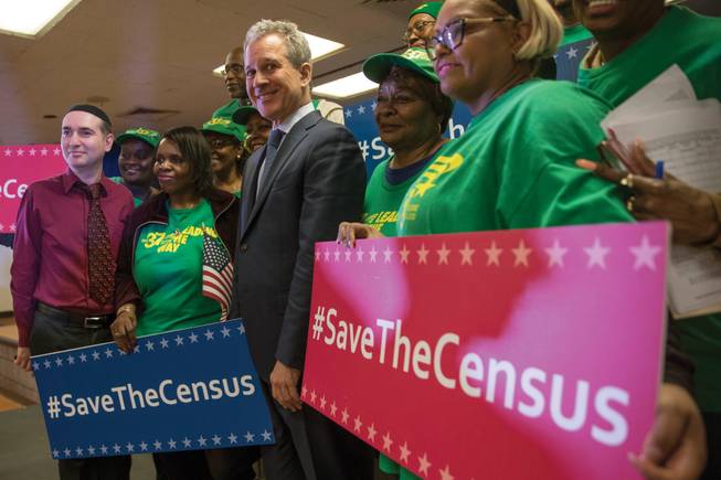 New York Attorney General Eric Schneiderman stands with members of District Council 37 after a news conference April 3 in New York. A lawsuit by 17 states, the District of Columbia and six cities against the U.S. government says a plan to add a citizenship question to the census questionnaire is unconstitutional. 