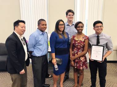 Southeast Career and Technical Academy seniors Deangelo Mortel, 17, Renae Sebastian, 18, and Spencer Ossa, 17, stand with local architects at the AIA Las Vegas High School Design Awards on April 18. The students were awarded $500 for their project, Radiant. 