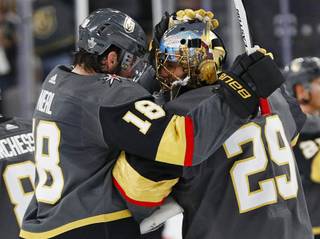 Vegas Golden Knights goaltender Marc-Andre Fleury (29) celebrates with left wing James Neal after the Golden Knights defeated the San Jose Sharks 7-0 in Game 1 of an NHL hockey second-round playoff series Thursday, April 26, 2018, in Las Vegas. (AP Photo/John Locher)