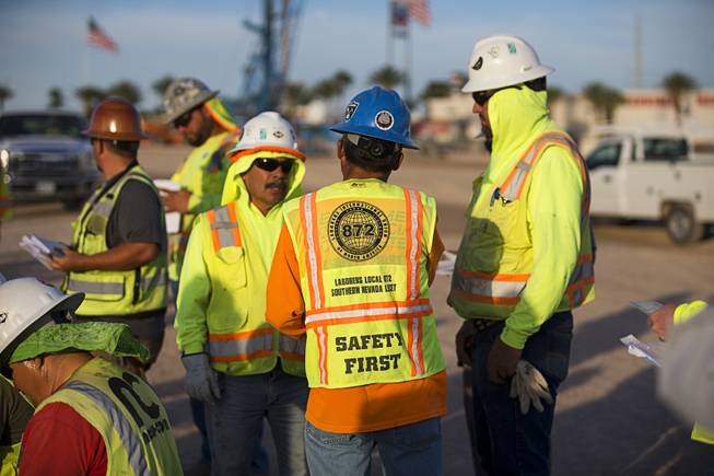 Workers gather for a morning safety meeting at the Las ...